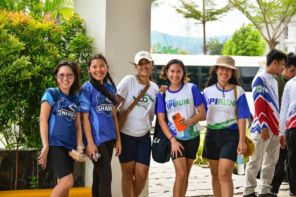 IPI employees planting mangrove propagules by hand across a tidal flat during the company’s EcoWellness mangrove planting day