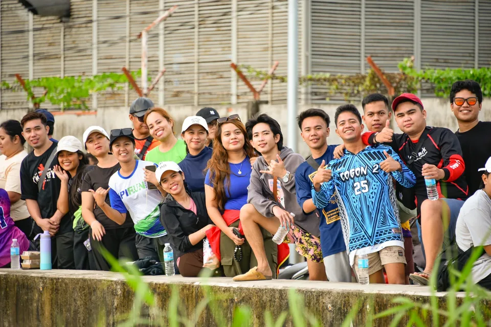 IPI employees planting mangrove propagules by hand across a tidal flat during the company’s EcoWellness mangrove planting day