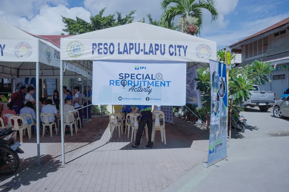 Applicants completing forms and meeting IPI recruiters at a PESO special recruitment activity held under tents in the city grounds