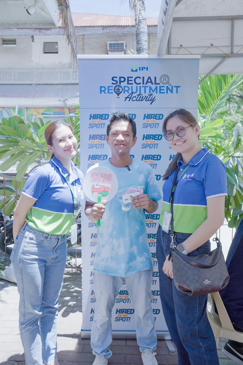 Applicants completing forms and meeting IPI recruiters at a PESO special recruitment activity held under tents in the city grounds